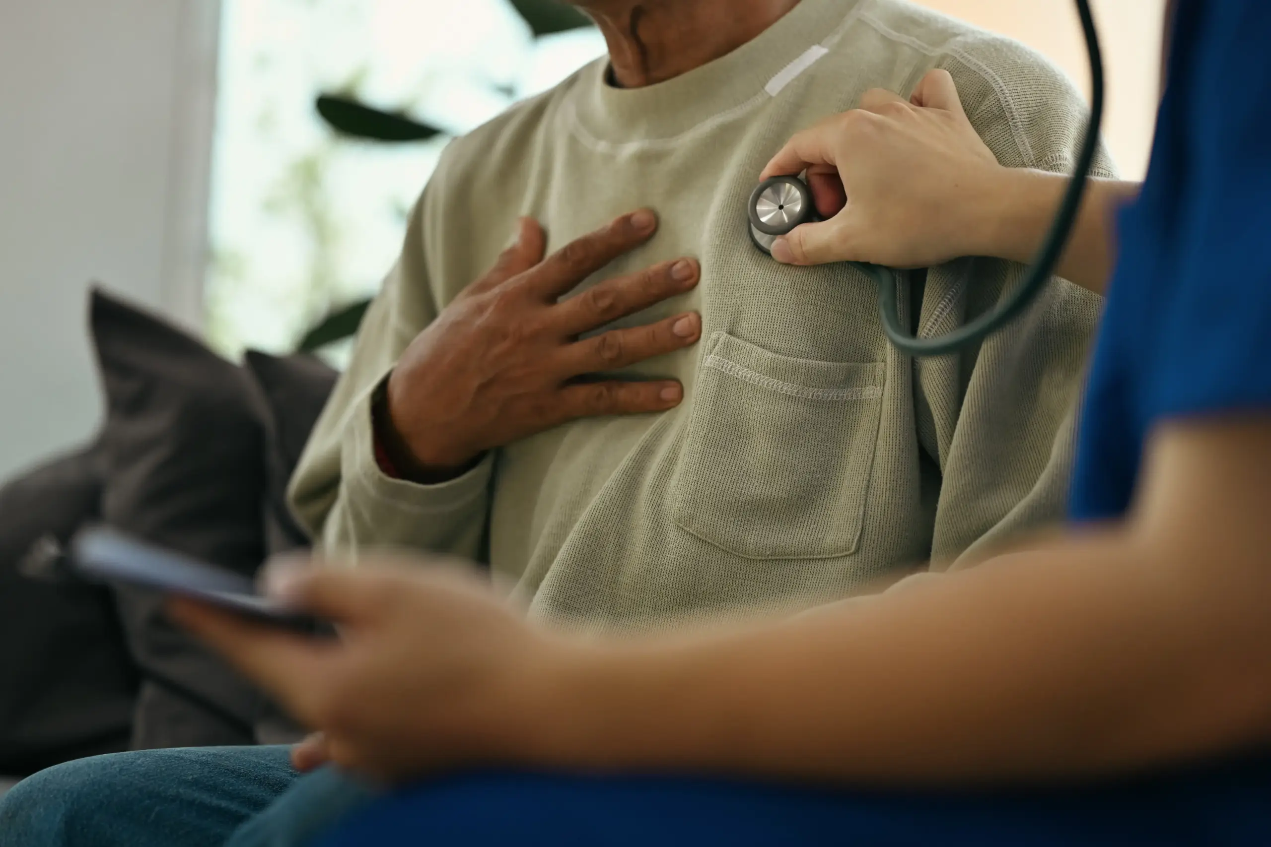 cropped-shot-doctor-holding-stethoscope-checking-heart-lungs-elderly-male-patient
