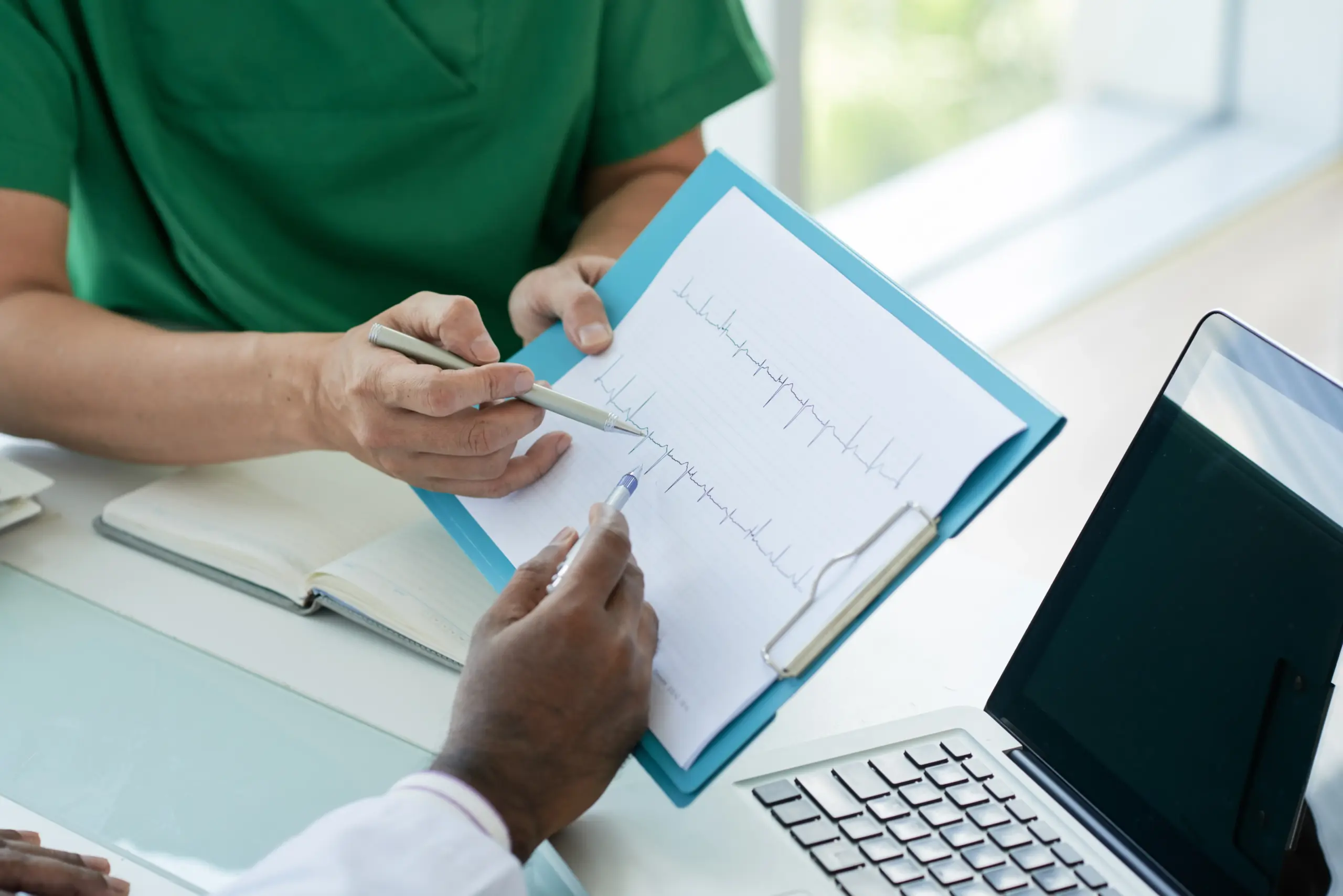 doctors-looking-cardiogram-their-patient